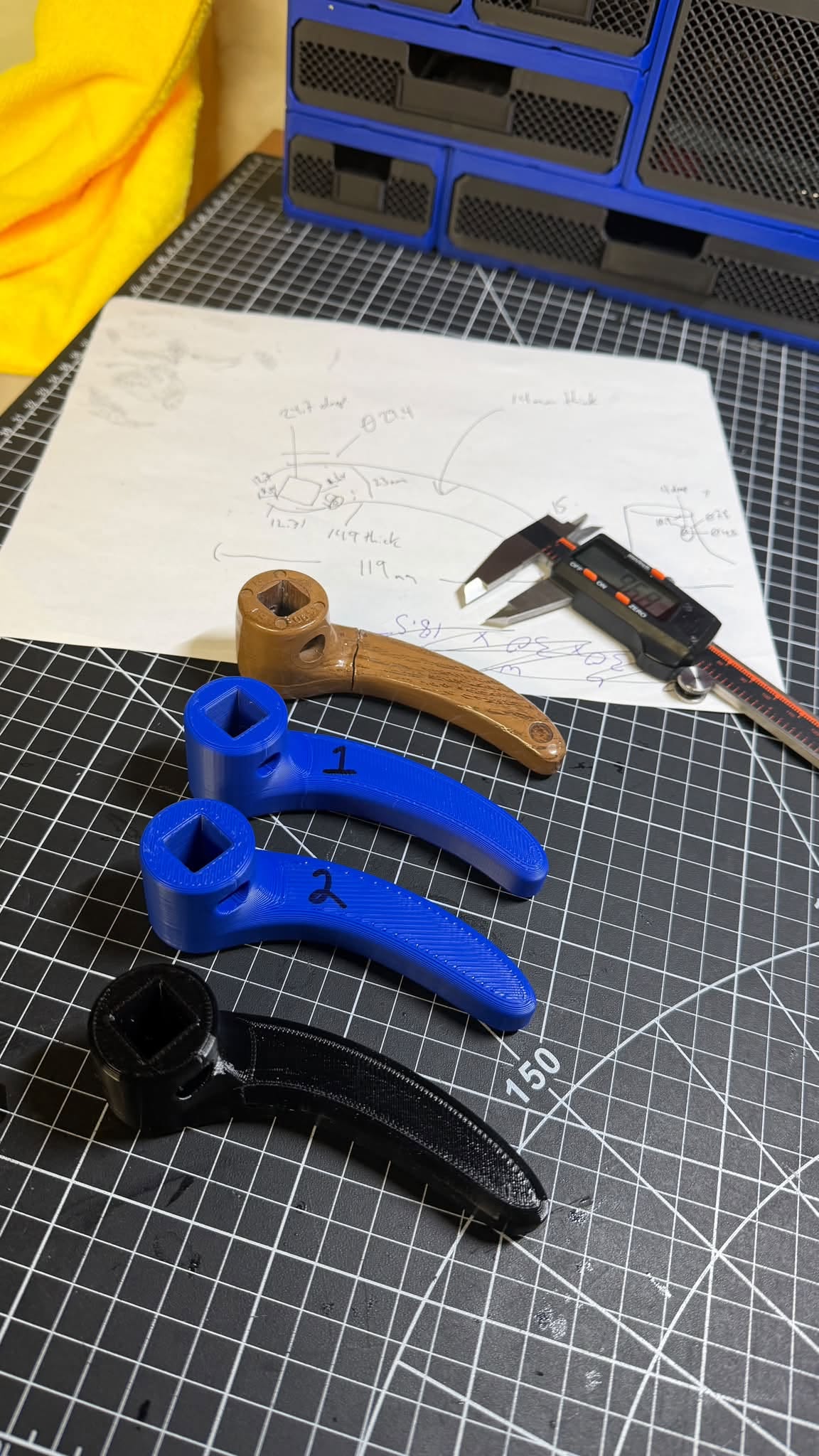 Original recliner handle, prototypes, and finished black polycarbonate handle
